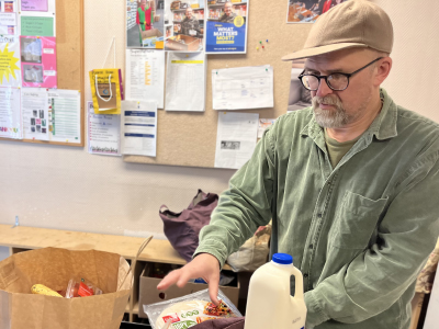 foodbank coordinator packing a food parcel