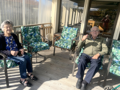 Residents in outside chairs at Iona 