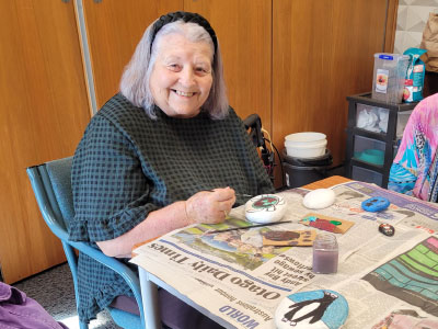 Resident painting rocks